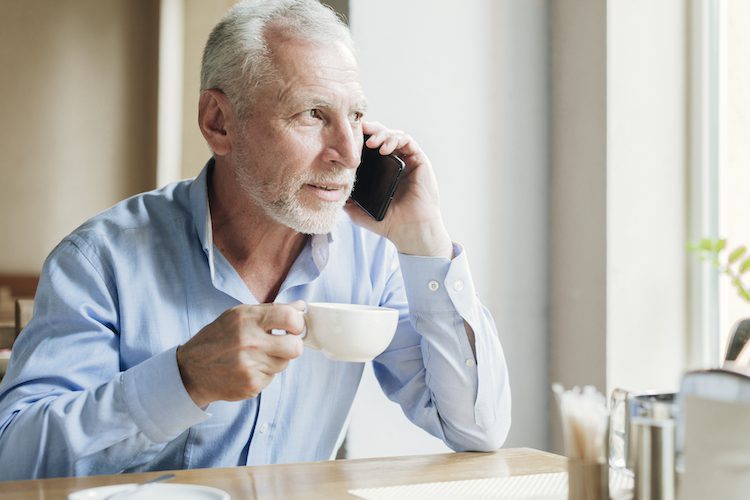 reifer-mann-am-telefon-mit-teetasse-1.jpg